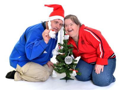 two adults with small christmas tree